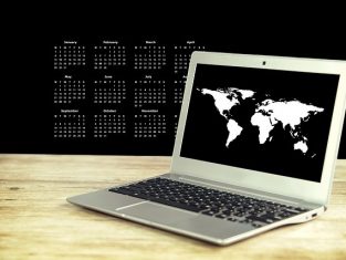 Laptop on a desk with dates behind