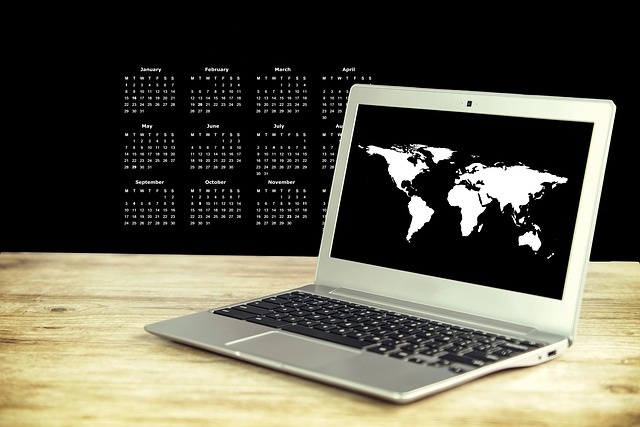 Laptop on a desk with dates behind