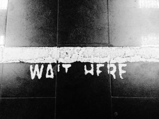 Wait here painted on the floor
