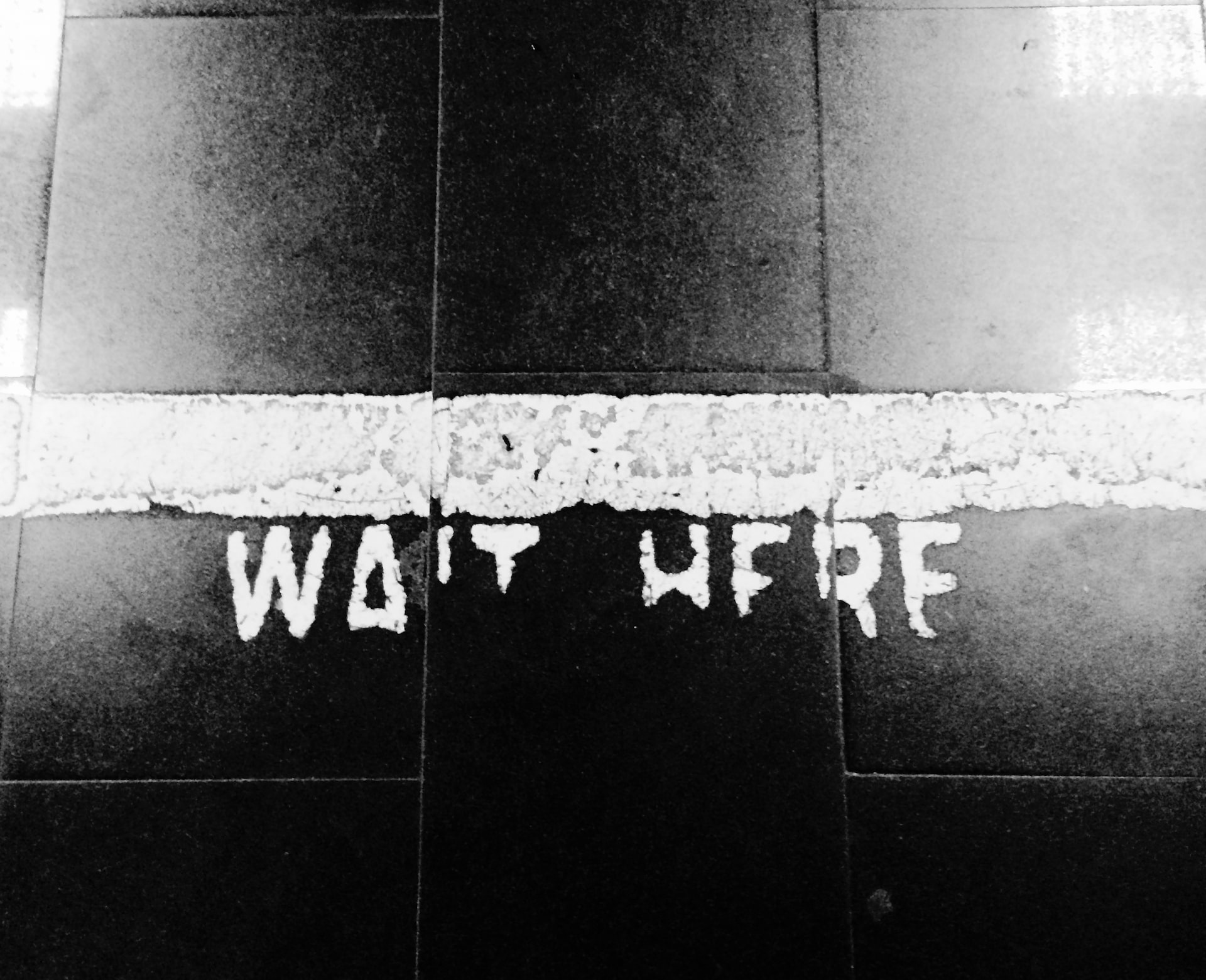 Wait here painted on the floor